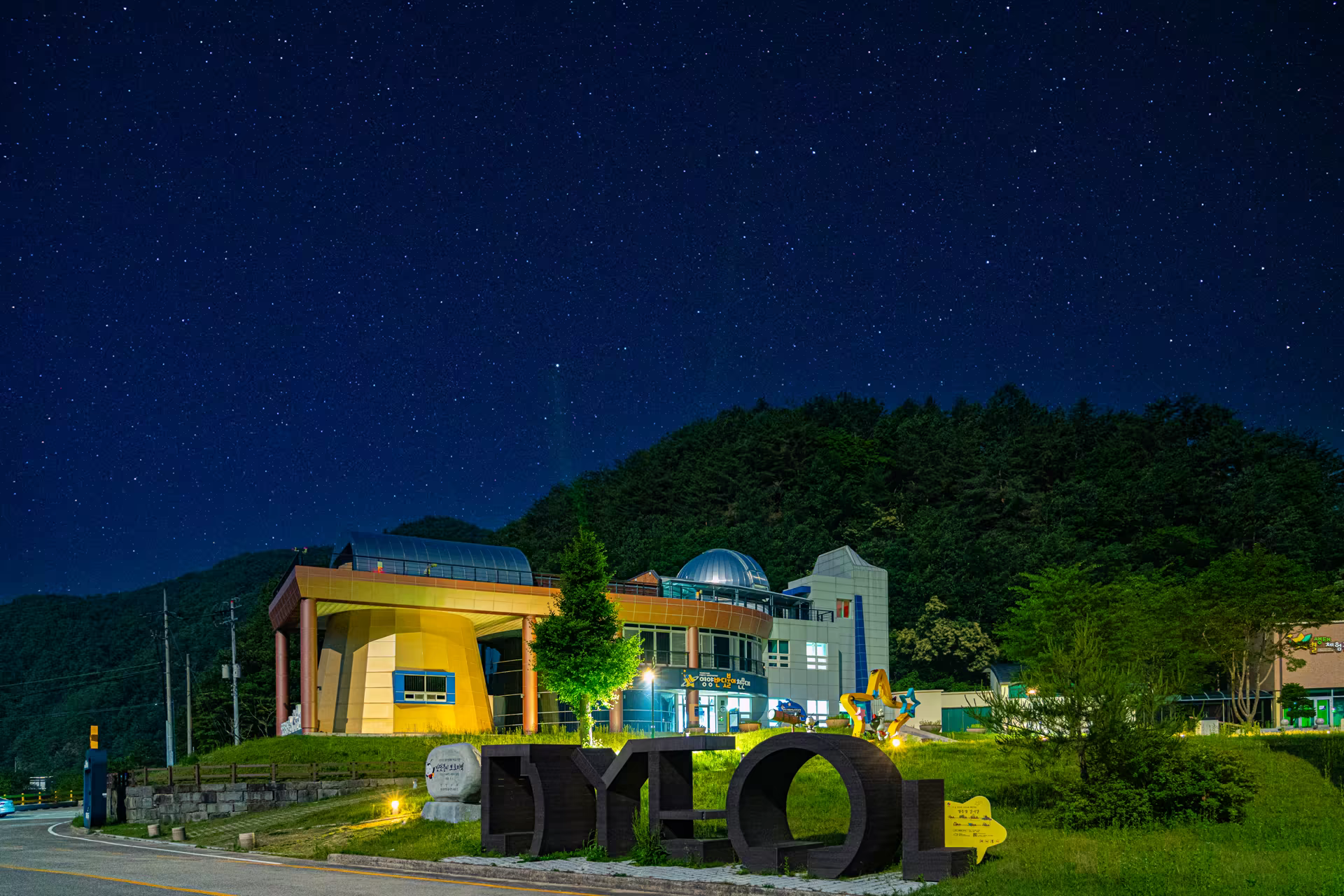 별이 떠 있는 밤하늘 아래 원통형 관측 돔이 솟은 영양반딧불이천문대 전경